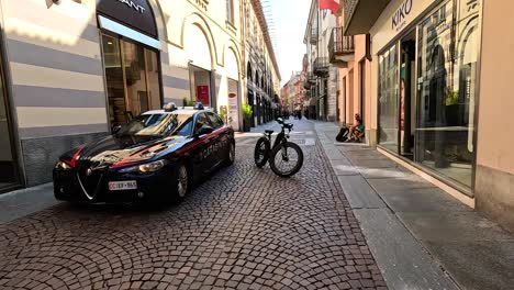 police car and cyclist in piedmont, italy