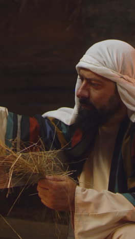 man preparing fire with straw