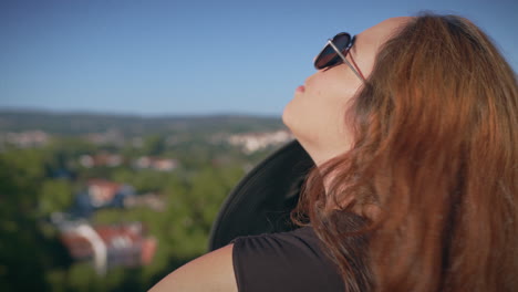 girl observes the cityscape from a viewpoint medium shot