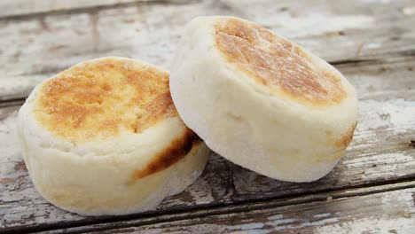 two bread buns arranged on wooden table