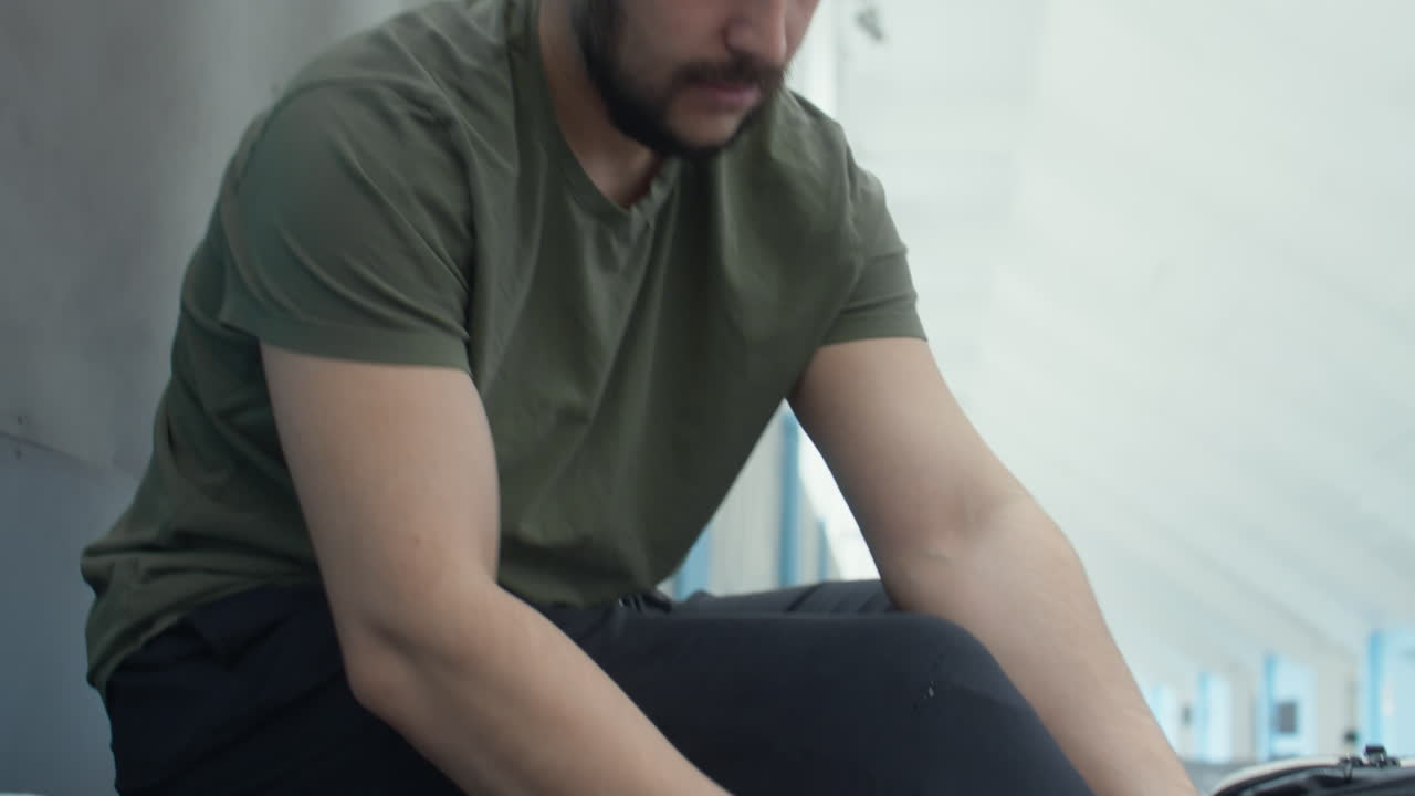 Sportsman Putting on Prosthetic Leg in Stadium