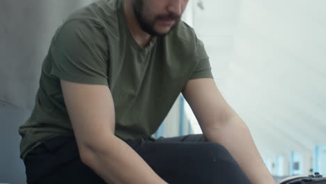 sportsman putting on prosthetic leg in stadium