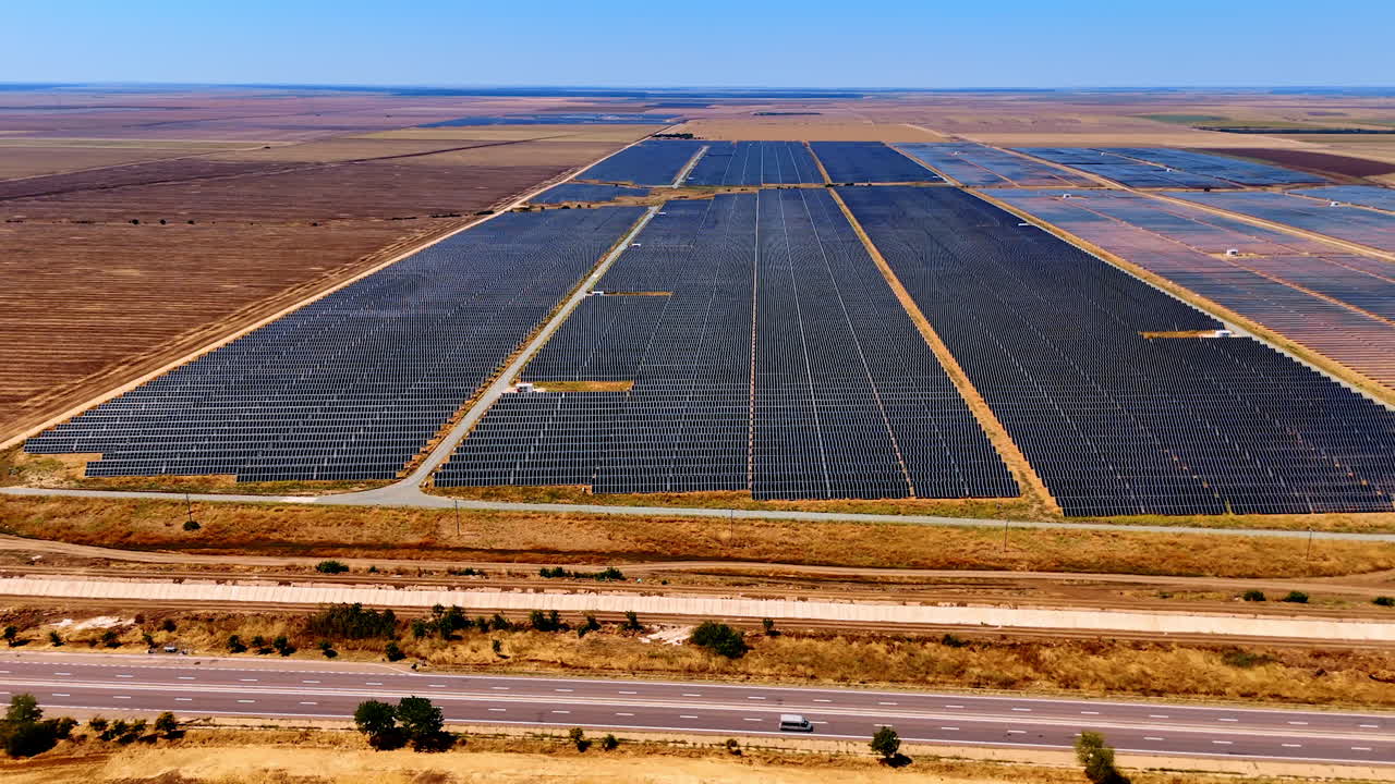 Solar panels on farm land. Expansive solar panel installation transforms farmland into renewable energy site under clear blue sky