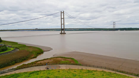 Aerial-drone-video-showcases-Humber-Bridge:-12th-largest-suspension-span-globally,-over-River-Humber,-connecting-Lincolnshire-to-Humberside-with-traffic