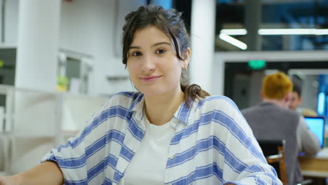 portrait of young cheerful businesswoman at office workplace