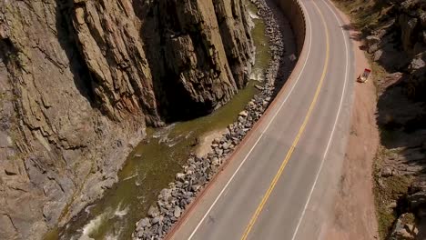 A-forward-flight-in-a-canyon-to-showcase-a-fly-fisherman-in-the-river-below