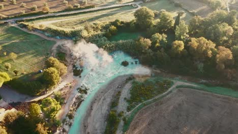 cascate del mulino, soothing natural hot springs bath, saturnia, tuscany, italy, europe, drone view traveling forward, tild down