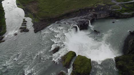 drone flying over large circulair formed waterfall with the camera tilted downwards in iceland in 4k