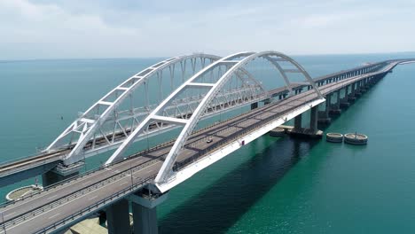 aerial view of a modern arch bridge over the water