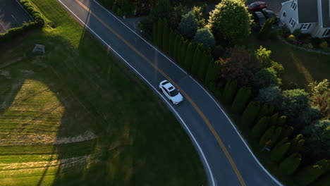 tracking shot of honda civic driving through residential neighborhood