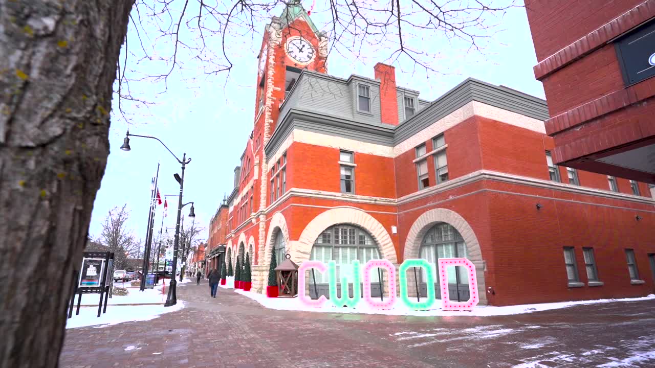 Walking towards a Collingwood sign on a snowy day in the downtown area