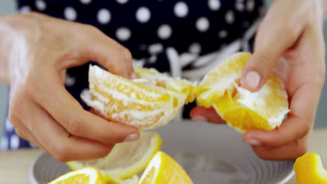 woman peeling orange