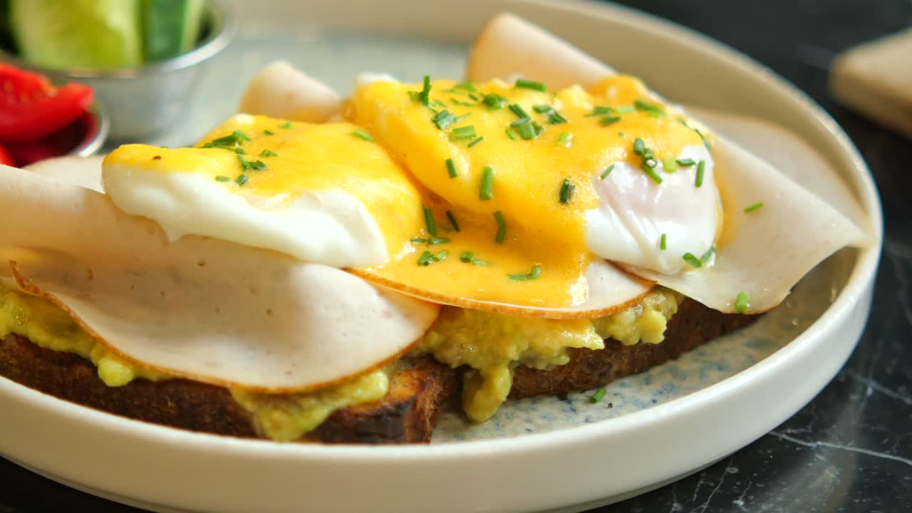Delicious Eggs Benedict with Avocado and Turkey Ham
