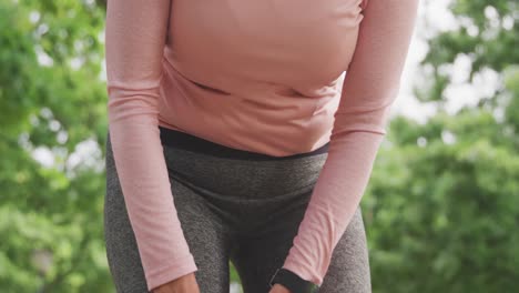 Senior-woman-in-pain-holding-her-leg-in-the-park