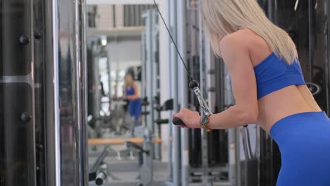woman working out on a cable machine in a gym
