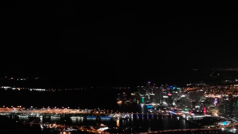 Landing-in-Boston-international-airport-at-night-time-aerial-city-view