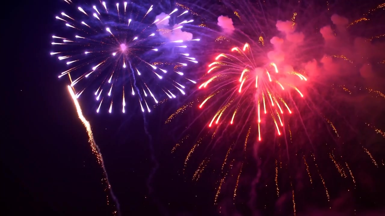 Successive aerial bursts bloom from left and right while bright rising streaks climb upward, leaving sparkling arcs and glowing smoke clouds in vivid magenta and purple light.