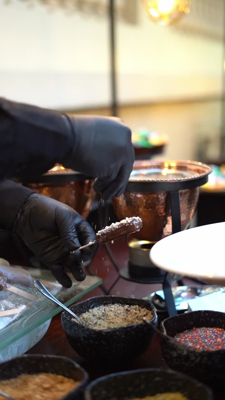A chief puts nuts ice creams, close up shot, insert shot