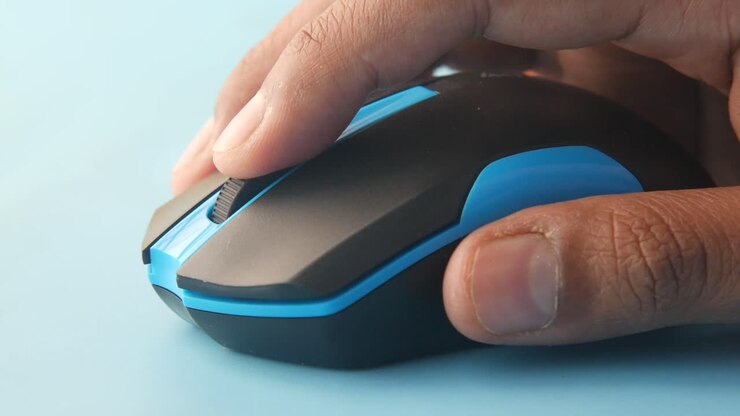 Hand holding a black computer mouse with blue accents