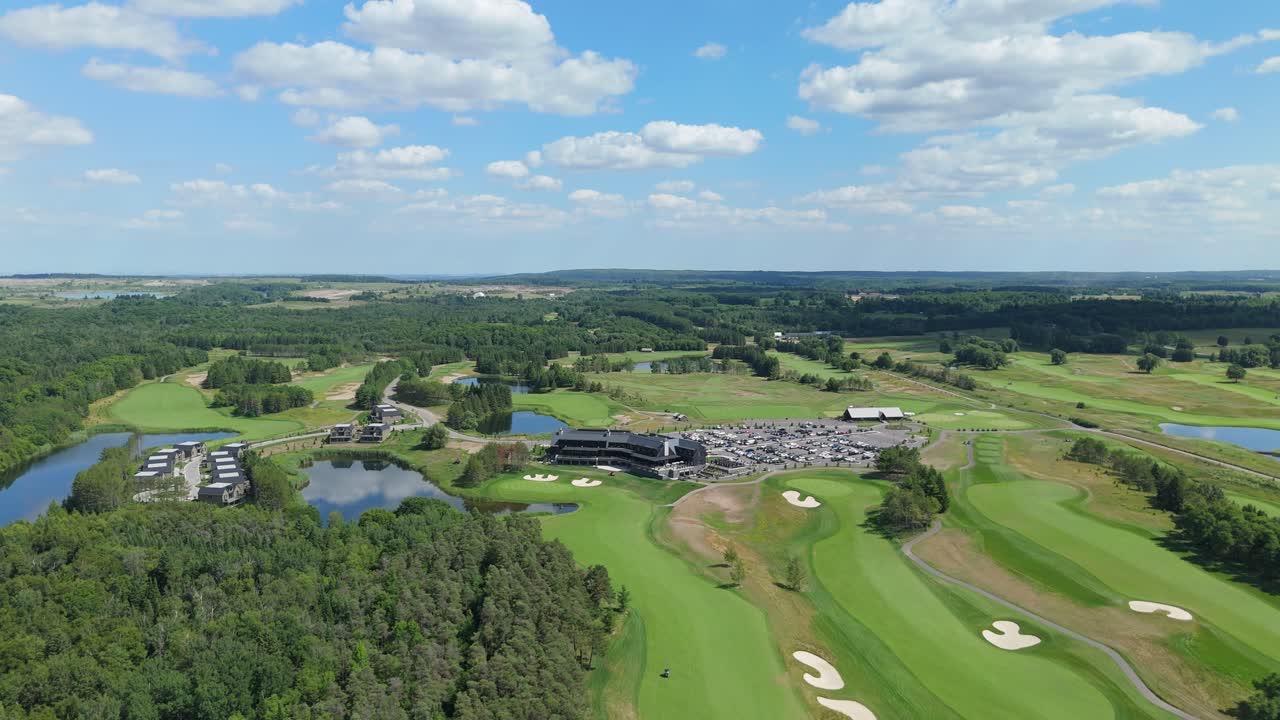 Drone flyover of TPC Toronto clubhouse and manicured greens in summer light