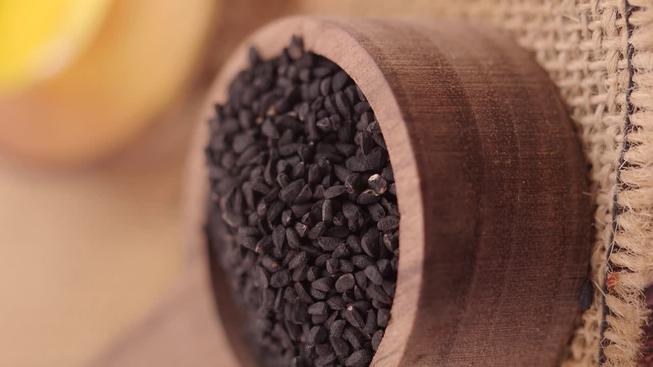 Close-up of Black Nigella Seeds in Wooden Spoon