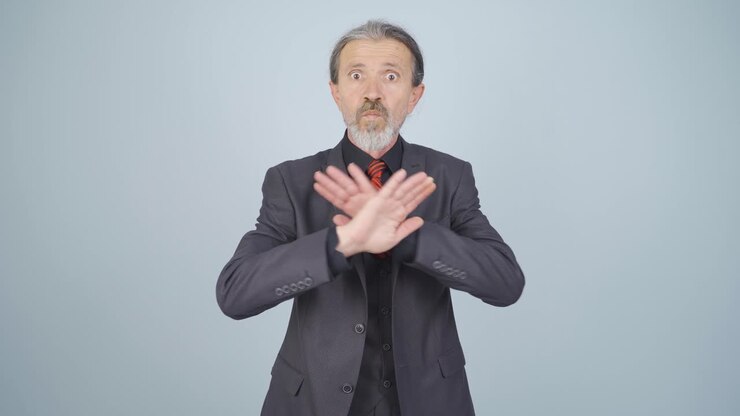 Businessman alerting camera with stern expression.