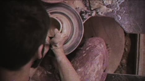 the potter makes a jug of clay. vintage effect. a man makes a vase on a potter's wheel