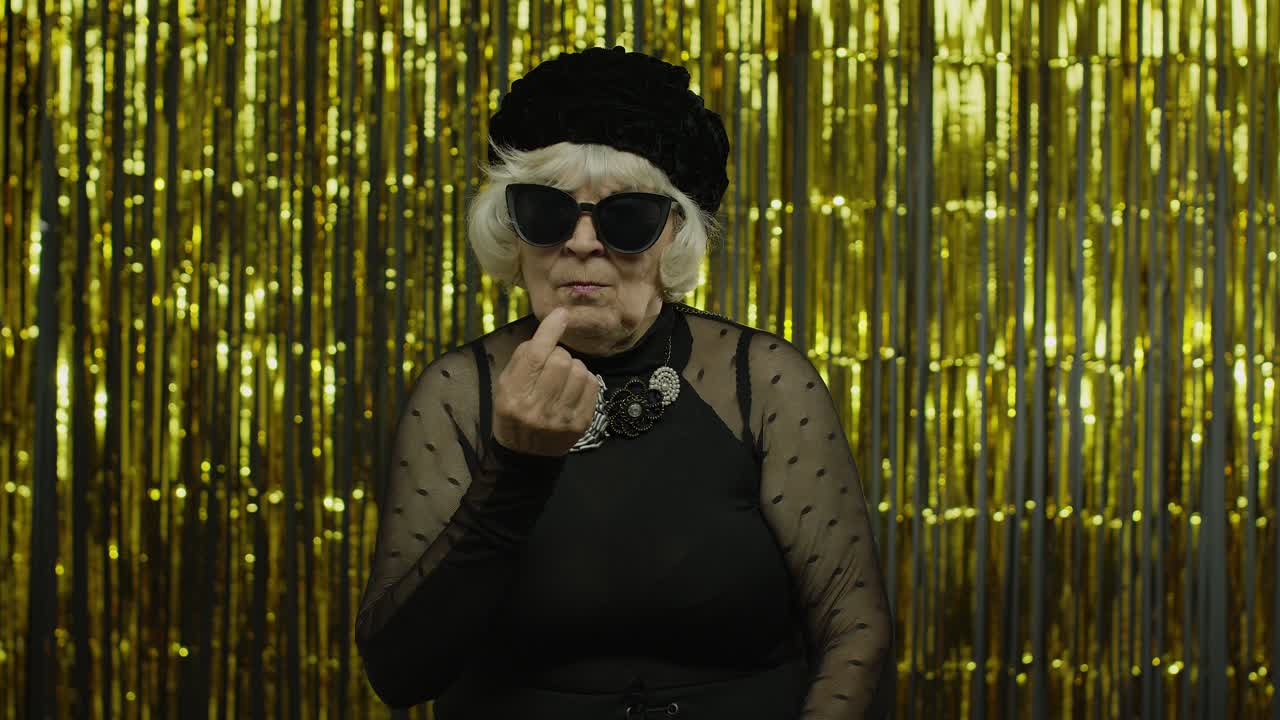 Funny stupid senior old woman picking nose with silly expression, removing boogers, bad manners