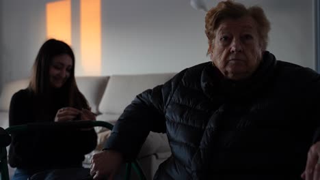 granny rise a hand in front of the camera to avoid to be filmed