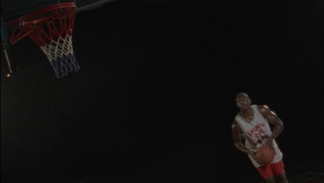 Two-men-play-basketball-on-an-indoor-court