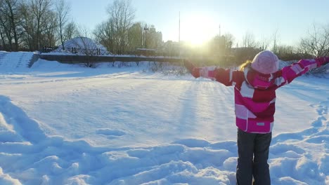 Back-view-little-girl-resting-with-mother.-Family-relaxing-in-winter-park