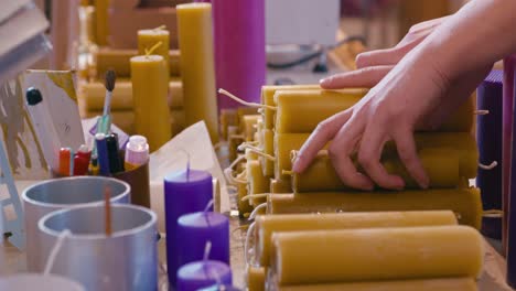 wax candles picked up by woman hands close up