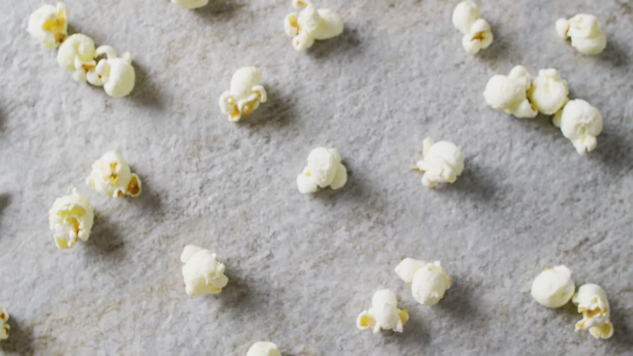 Video of close up of popcorn on gray background