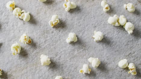 video of close up of popcorn on gray background