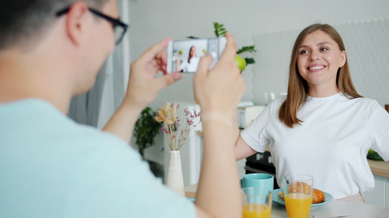 Couple taking a photo in the kitchen