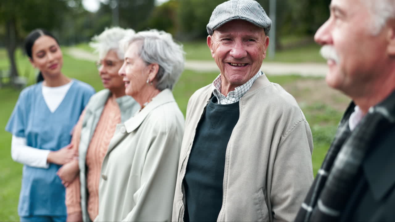 Group of elderly people with caregivers outdoors