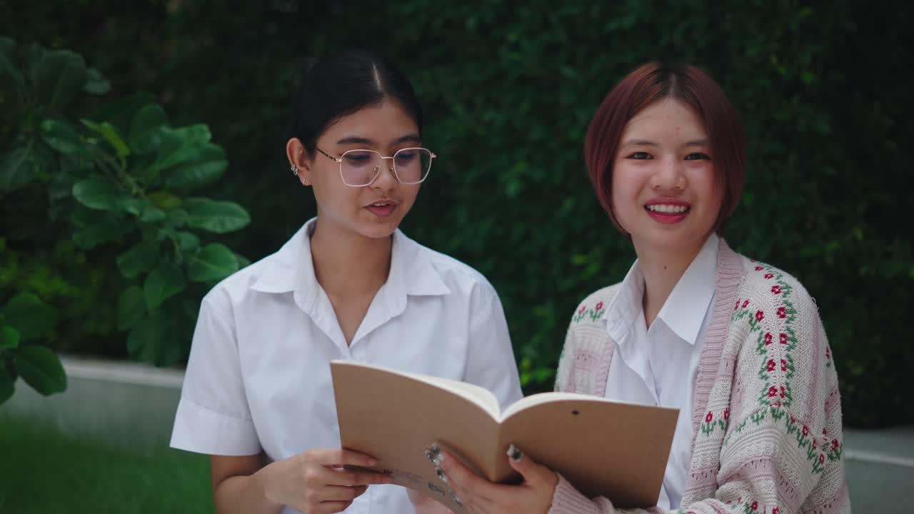 Two Teen Girls Studying Outdoors