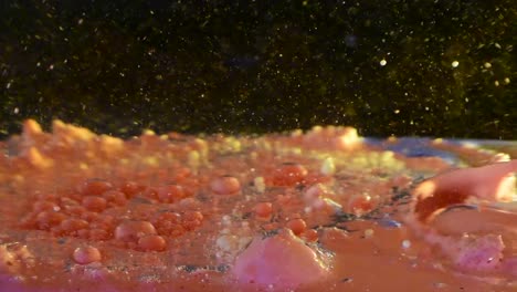 alien planet liquid surface stirring oil and color loops and swooshes with bubble and debris fallout 60fps