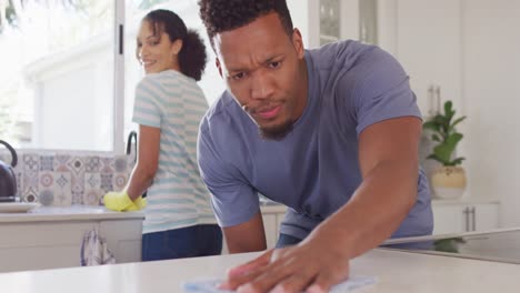 Happy-african-american-couple-washing-dishes-in-kitchen