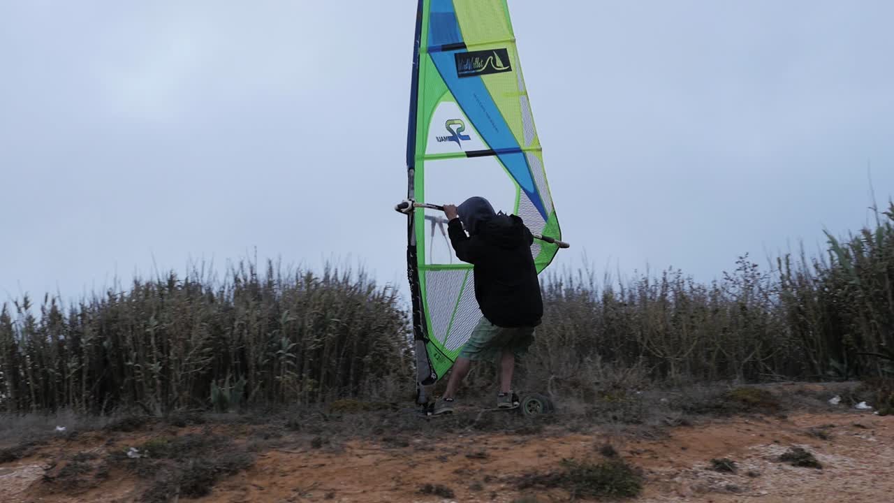 Slow motion of Portuguese windsurfer trying out his sail on a skate and going super fast!