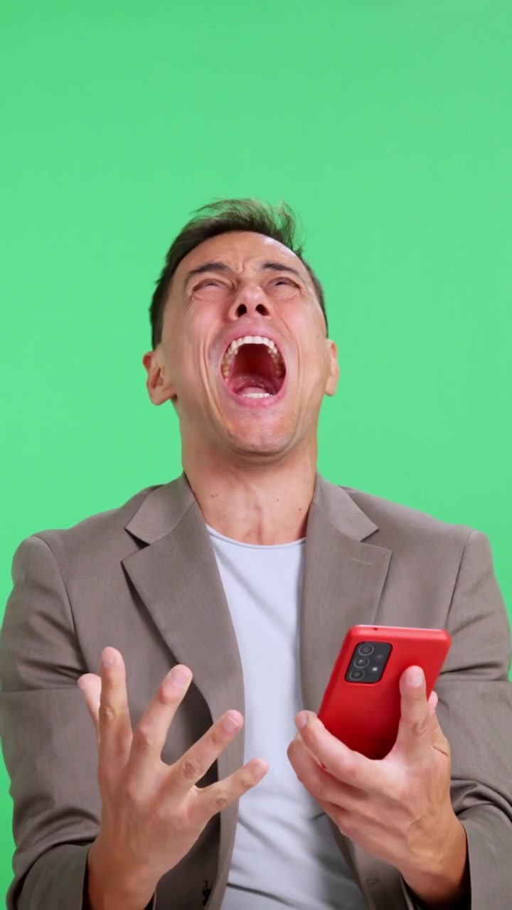 Empresario emocionado ganando mientras usa el smartphone en pantalla verde