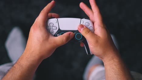 Top-down-view-of-close-up-of-hands-playing-video-game