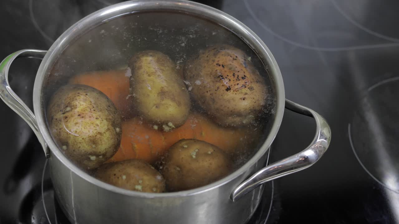 Pentola bollente con verdure, patate e carote. Cucinare in cucina.