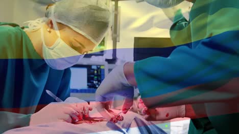 Animation-of-flag-of-colombia-waving-over-surgeons-in-operating-theatre