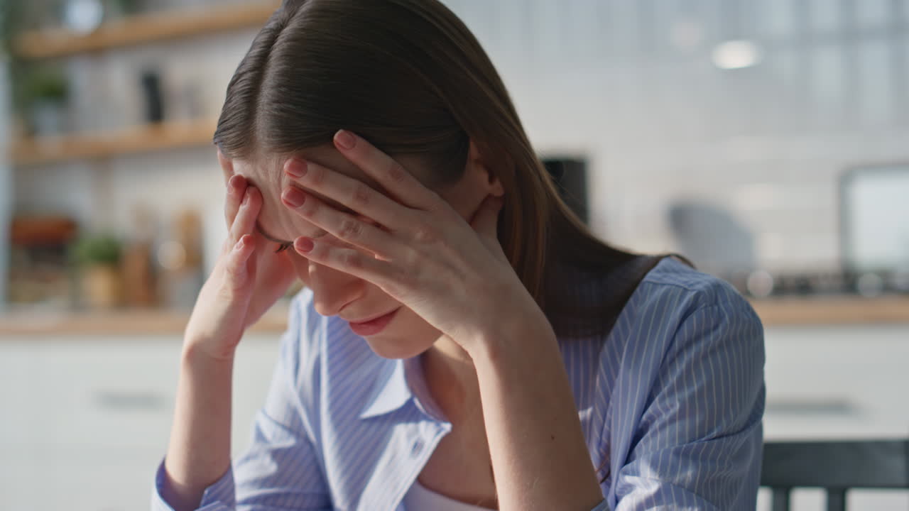 Unhappy woman finish call by mobile phone in home closeup. Sorrowful young lady