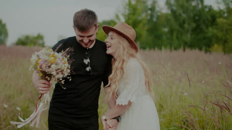 Carefree-Couple-In-Love-Walking-On-A-Meadow-In-Countryside-On-Holidays