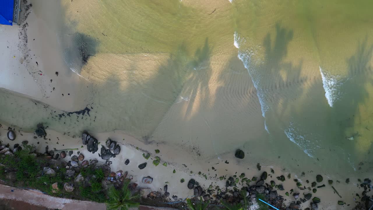 koh rong island in Cambodia, showing colorful stilt houses, piers and fishing boats in turquoise water. Tremendous aerial view flight drone camera pointing down