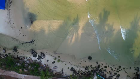 koh rong island in Cambodia, showing colorful stilt houses, piers and fishing boats in turquoise water. Tremendous aerial view flight drone camera pointing down