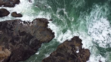 4K-30FPS-Drone-Footage-of-Thor's-Well,-Spouting-Horn-along-the-Oregon-Pacific-Northwest-Coast---Aerial-View-Turquoise-Blue-Water,-Seagulls-Flying,-Waves-Crashing,-Rocks-Shimmering-from-Setting-Sun