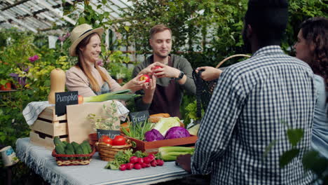 people shopping at a farmers market in a greenhouse